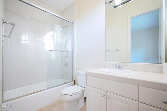 full bathroom with tile patterned flooring, vanity, toilet, and enclosed tub / shower combo