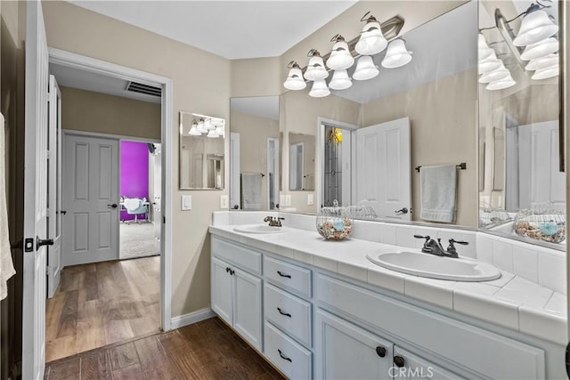 bathroom with vanity and hardwood / wood-style flooring