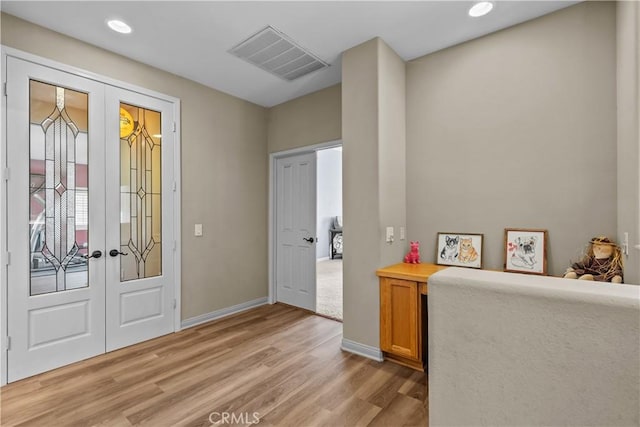 foyer featuring french doors and light hardwood / wood-style floors