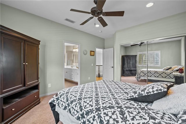 carpeted bedroom with ceiling fan, connected bathroom, and a closet