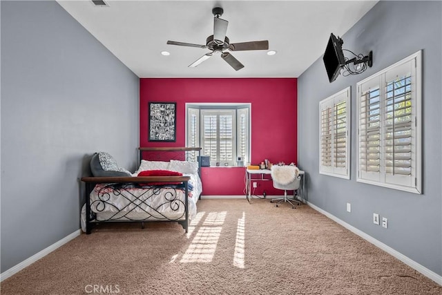 bedroom with carpet floors, multiple windows, and ceiling fan