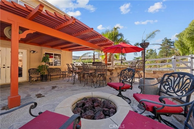 view of patio / terrace with a bar and a fire pit