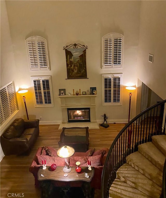 living room featuring hardwood / wood-style flooring and a high ceiling