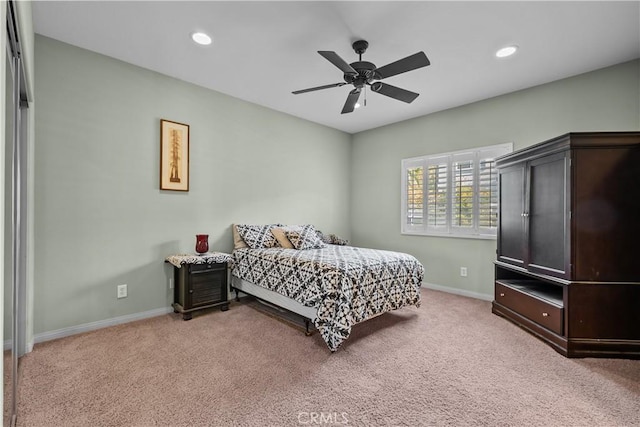 bedroom with ceiling fan and light colored carpet