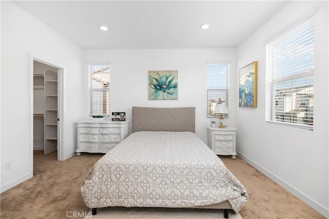 bedroom featuring carpet, a closet, and a walk in closet