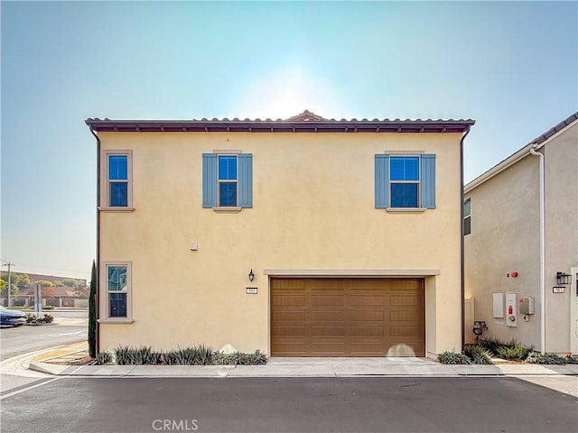 mediterranean / spanish-style home featuring a garage