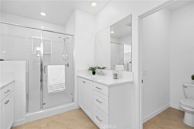 bathroom featuring toilet, vanity, walk in shower, and tile patterned flooring