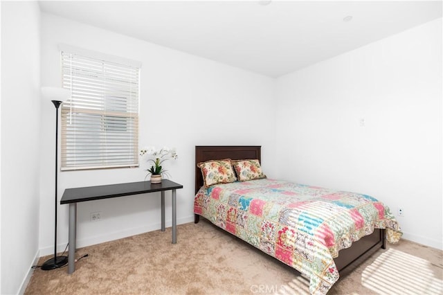 bedroom featuring light carpet