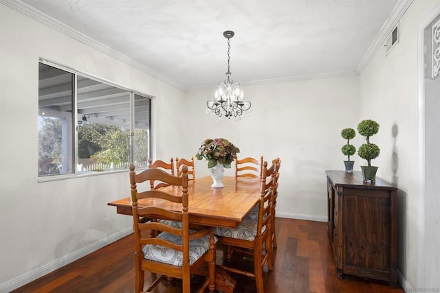 dining room with ornamental molding, an inviting chandelier, and dark wood-type flooring