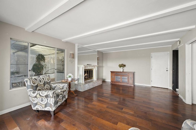 living area with beam ceiling and dark hardwood / wood-style flooring