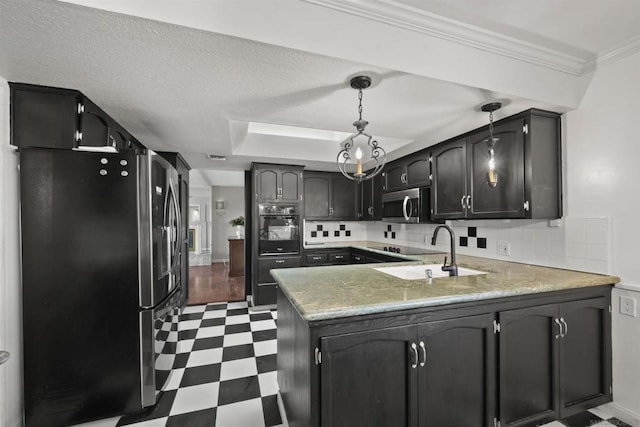 kitchen featuring appliances with stainless steel finishes, backsplash, crown molding, sink, and decorative light fixtures