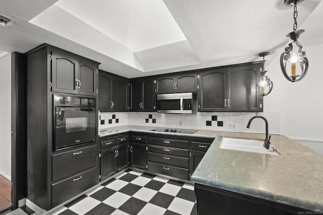 kitchen featuring black appliances, a raised ceiling, sink, decorative backsplash, and a textured ceiling