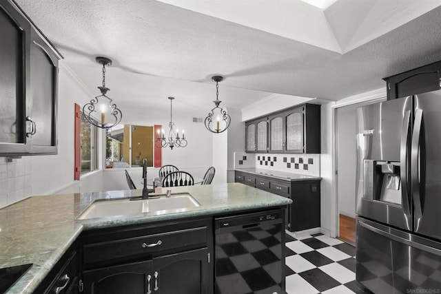 kitchen featuring tasteful backsplash, a textured ceiling, sink, black appliances, and a notable chandelier