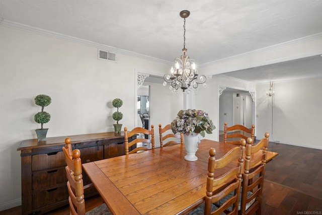 dining area featuring a notable chandelier, crown molding, and dark wood-type flooring