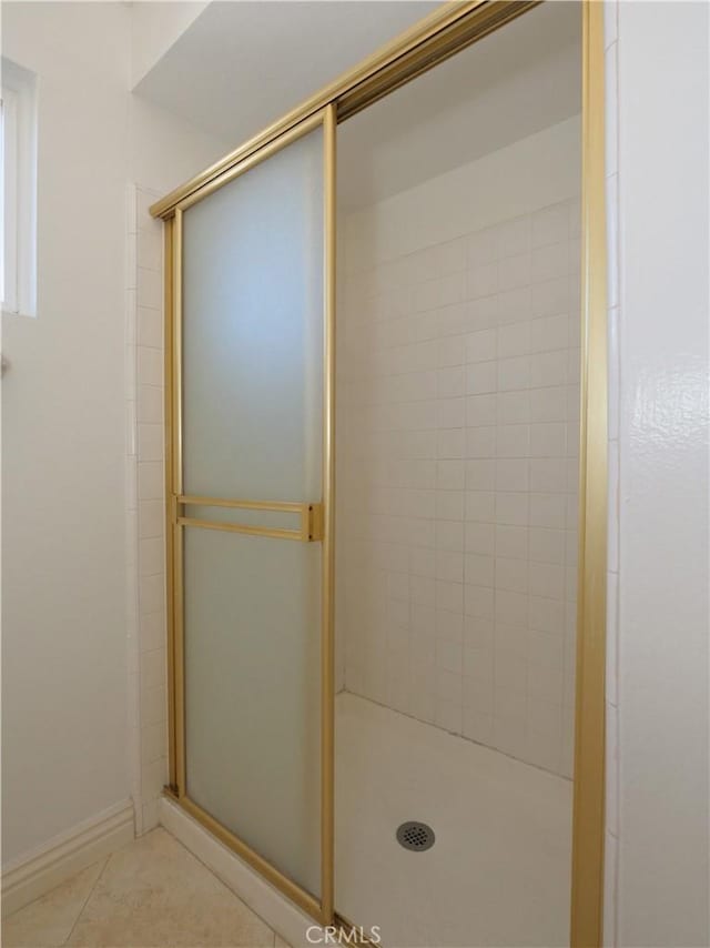 bathroom featuring an enclosed shower and tile patterned flooring