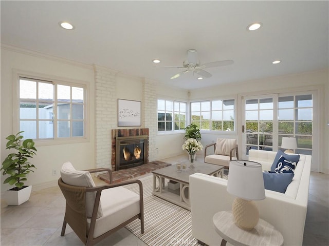 sunroom with ceiling fan, a healthy amount of sunlight, and a brick fireplace