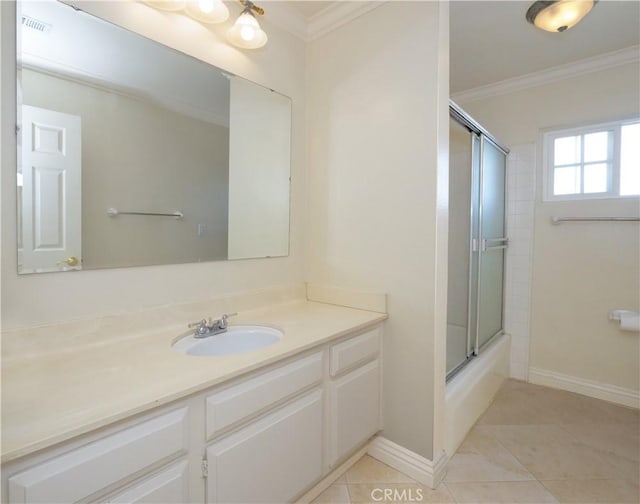 bathroom with bath / shower combo with glass door, vanity, crown molding, and tile patterned flooring