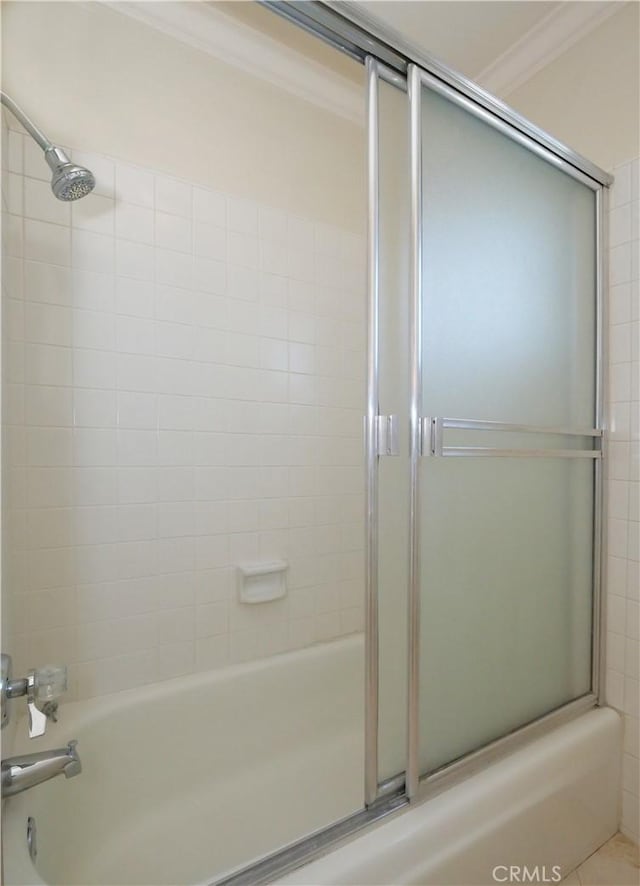 bathroom featuring combined bath / shower with glass door, crown molding, and tile patterned flooring