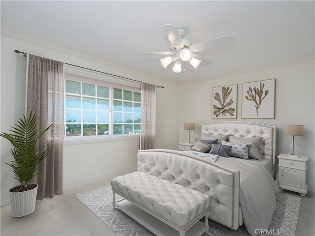 bedroom with baseboards, carpet floors, ceiling fan, and crown molding