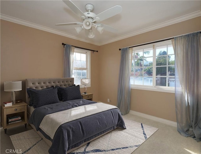 carpeted bedroom with ceiling fan and ornamental molding