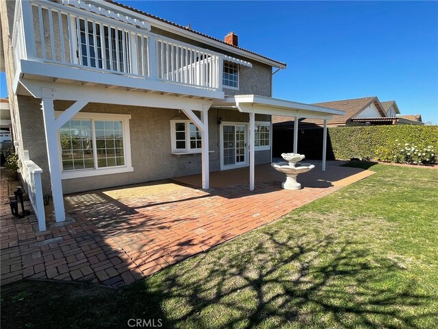28708 Mount Sawtooth Dr, Rancho Palos Verdes, CA 90275 - back of property with a patio, stucco siding, a balcony, a chimney, and a lawn