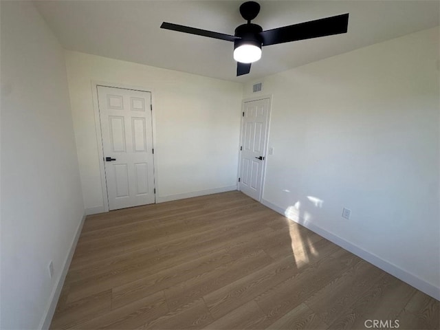 spare room with light hardwood / wood-style floors and ceiling fan