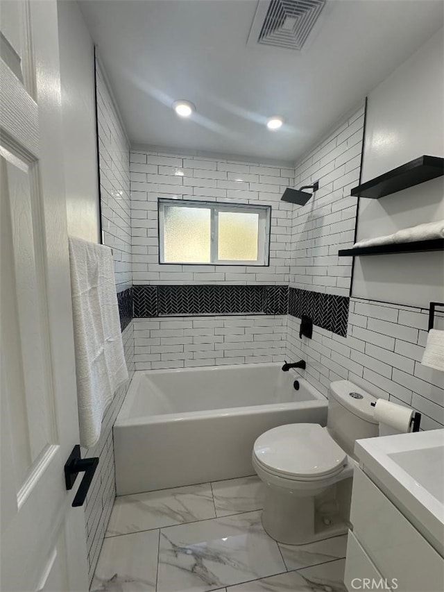 full bathroom with vanity, toilet, and tiled shower / bath