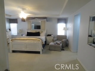 bedroom with ceiling fan, multiple windows, and carpet flooring