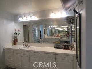 bathroom with an AC wall unit and sink