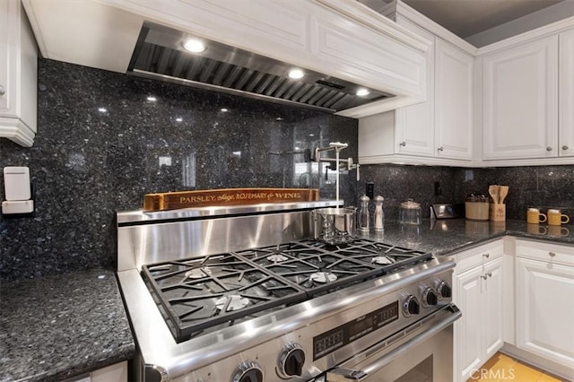 kitchen with white cabinets, gas stove, and premium range hood