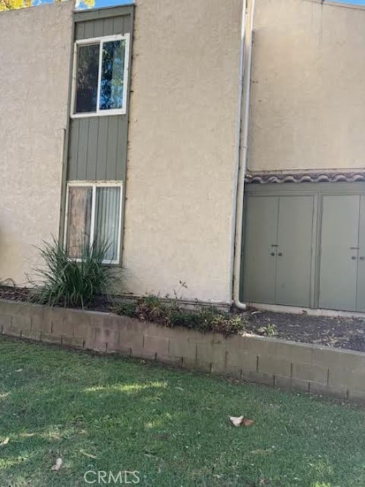 view of side of home with a lawn