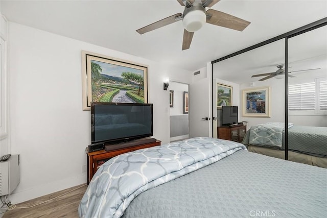 bedroom featuring a closet, ceiling fan, and light wood-type flooring