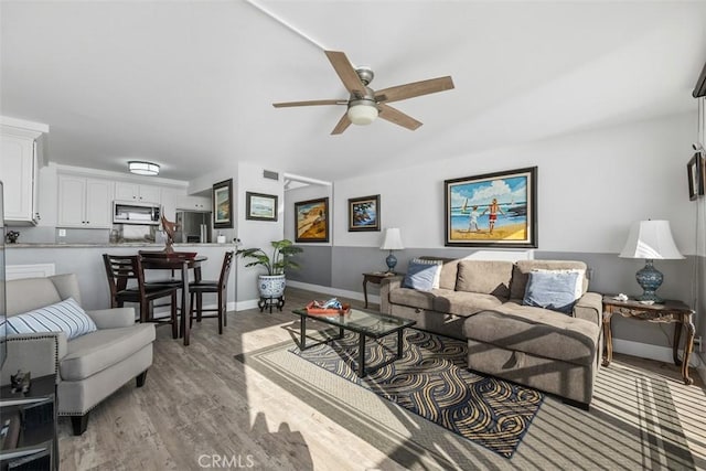 living room featuring ceiling fan and light wood-type flooring