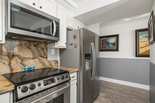 kitchen with stainless steel appliances, white cabinetry, dark hardwood / wood-style floors, and backsplash