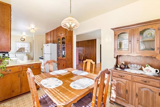 dining room with an inviting chandelier and washer and dryer