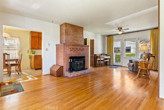 living room with wood-type flooring and ceiling fan with notable chandelier