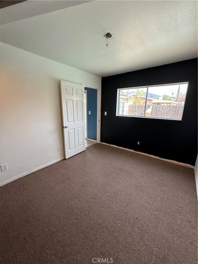 spare room with a textured ceiling