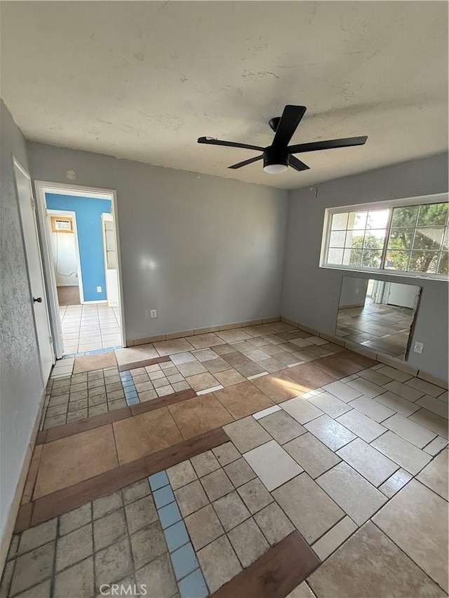 unfurnished room with ceiling fan