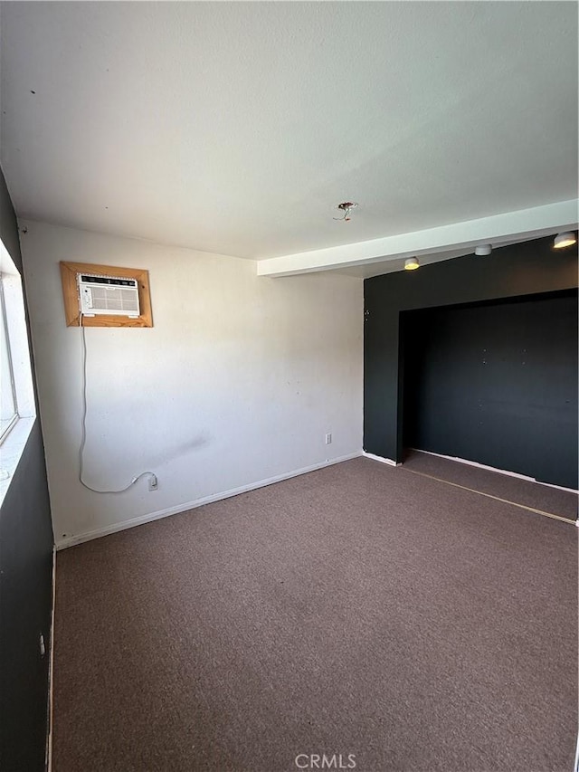 unfurnished room with carpet flooring and an AC wall unit