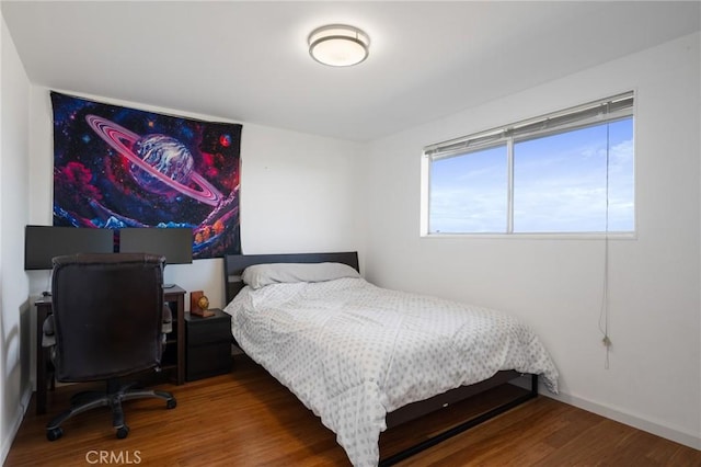 bedroom with wood-type flooring