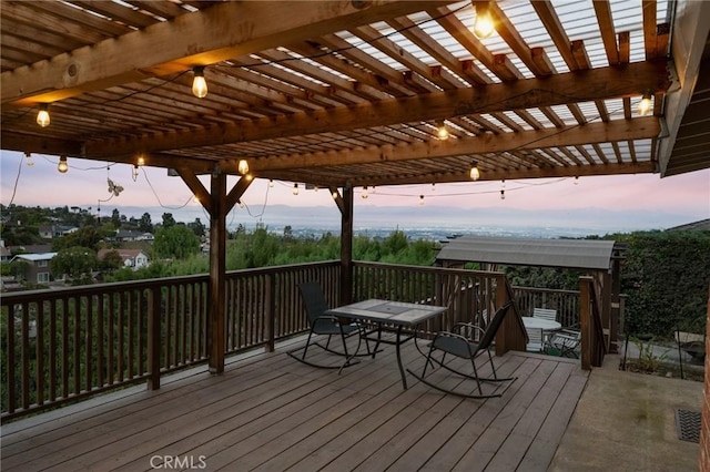 deck at dusk with a pergola