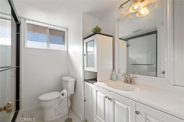 bathroom with tile patterned floors, vanity, toilet, and a shower with door