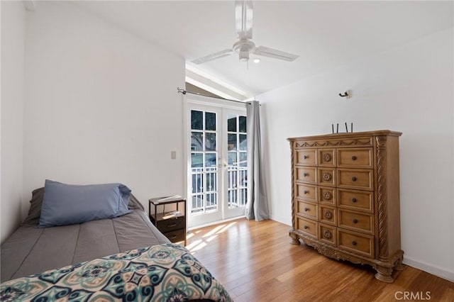 bedroom featuring access to exterior, french doors, vaulted ceiling, ceiling fan, and hardwood / wood-style floors