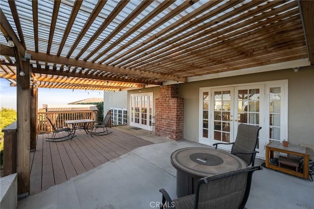 exterior space with french doors, a pergola, and a wooden deck