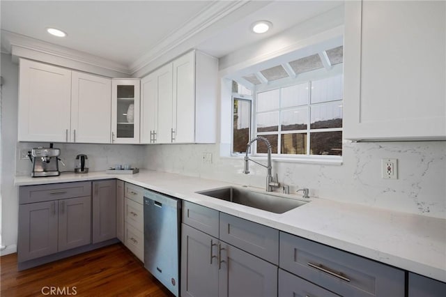 kitchen with dark hardwood / wood-style flooring, stainless steel dishwasher, crown molding, sink, and gray cabinets