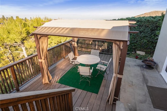 wooden terrace featuring a gazebo