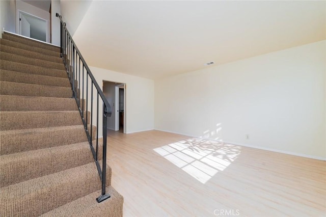 stairway with hardwood / wood-style floors