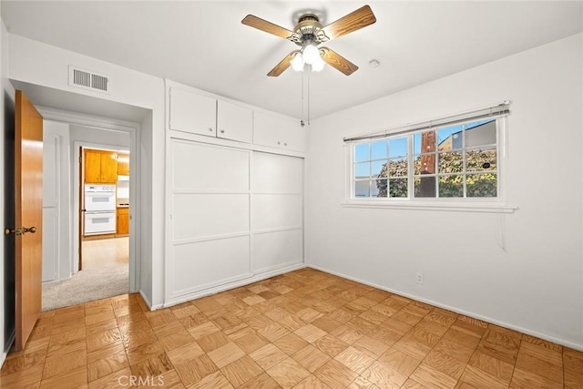 unfurnished bedroom featuring a closet and ceiling fan