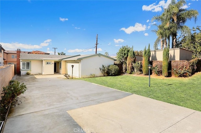 view of front of home with a front yard and a garage