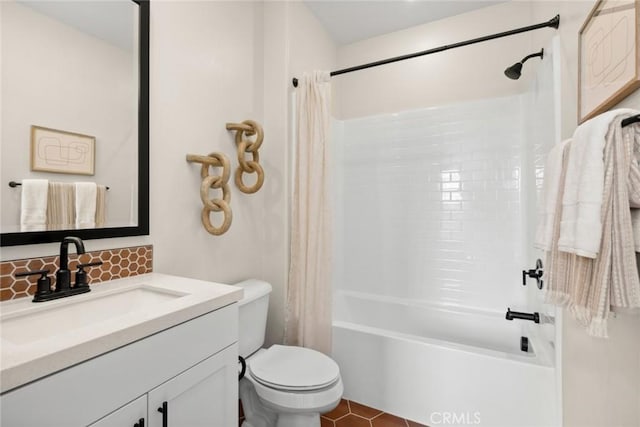 full bathroom featuring toilet, tile patterned floors, vanity, and shower / bath combo with shower curtain